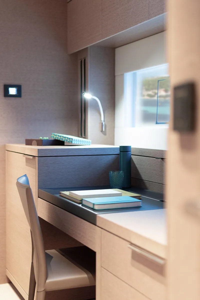 Slide: The Image of Luxurious interior of 2025 Lagoon SIXTY 5 yacht with modern desk and ambient lighting. - 44