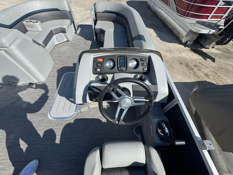 Slide: The Image of 2022 Bennington 23 SXSR boat interior with steering wheel and seating area. - 10