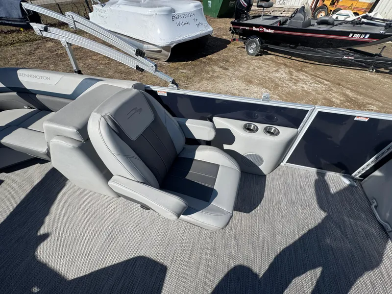 Slide: The Image of 2022 Bennington 23 SXSR boat interior with gray seating and cup holders. - 11