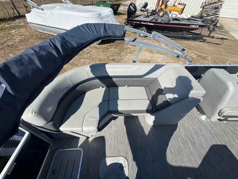 Slide: The Image of 2022 Bennington 23 SXSR boat interior with gray seating and carpeted floor. - 13