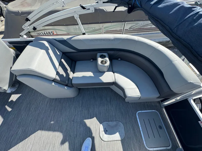 Slide: The Image of 2022 Bennington 23 SXSR boat interior with gray seating and cup holder. - 14
