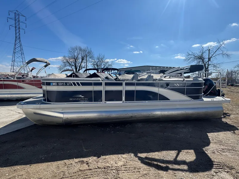 Slide: The Image of 2022 Bennington 23 SXSR pontoon boat parked outdoors on a sunny day. - 3