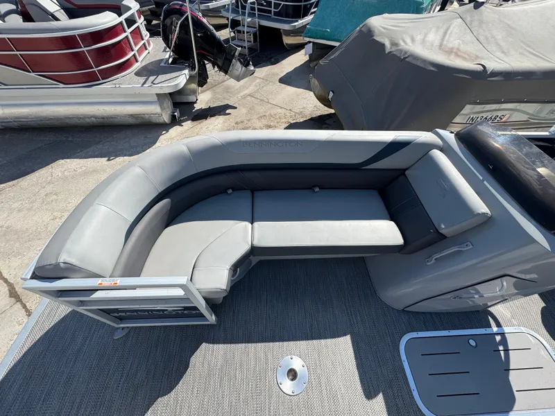 Slide: The Image of 2022 Bennington 23 SXSR boat with gray seating and deck, docked outdoors. - 5