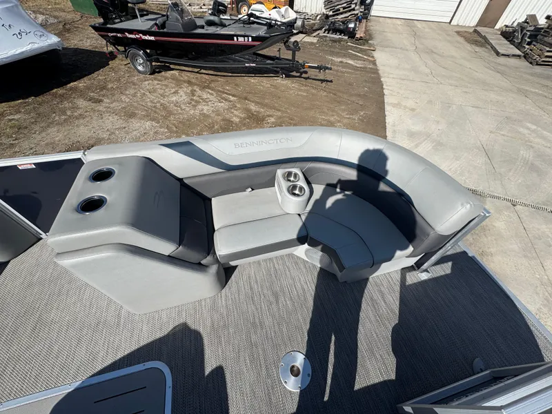 Slide: The Image of 2022 Bennington 23 SXSR boat interior with gray seating and cup holders. - 6