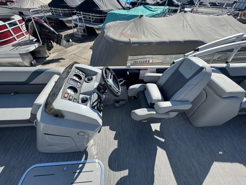 Slide: The Image of 2022 Bennington 23 SXSR boat interior with steering console and captain's chair. - 8