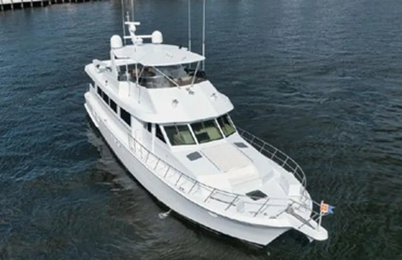 Slide: The Image of 1998 Hatteras 74 Cockpit Motor Yacht cruising on open water. - 3