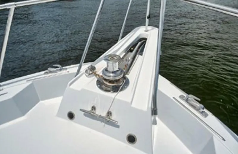 Slide: The Image of 1998 Hatteras 74 Cockpit Motor Yacht bow with anchor winch on calm water. - 39