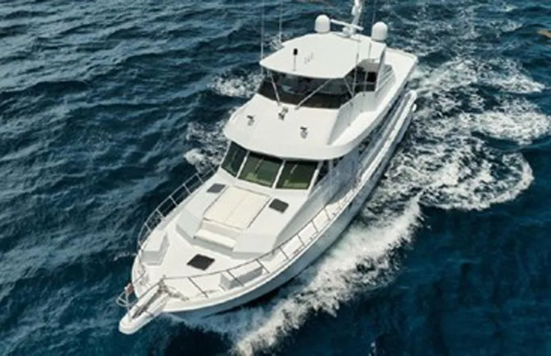 Slide: The Image of 1998 Hatteras 74 Cockpit Motor Yacht cruising on open sea. - 4