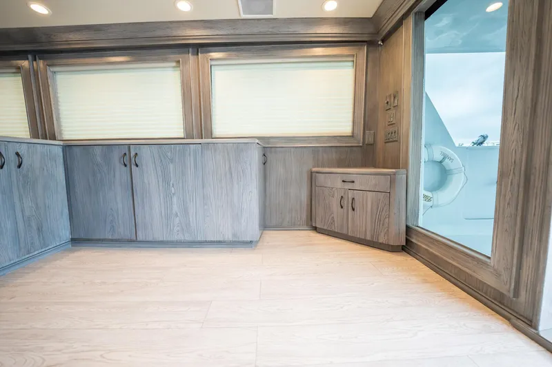 Slide: The Image of Interior of 1998 Hatteras 74 Cockpit Motor Yacht with wood cabinetry and large windows. - 7