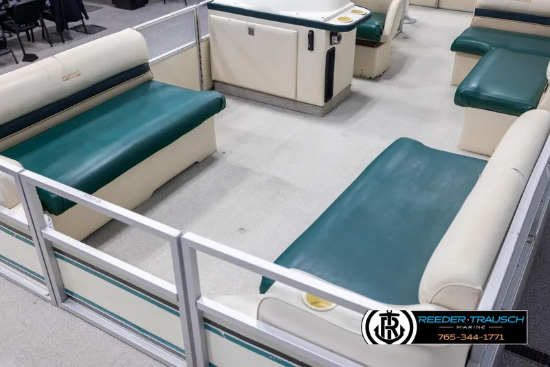 Slide: The Image of 1998 Crest 22 DLX boat interior with green and cream seating. - 10