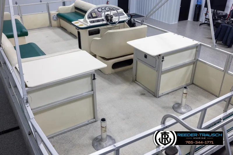 Slide: The Image of 1998 Crest 22 DLX pontoon boat interior with seating and steering console. - 11