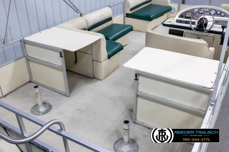 Slide: The Image of 1998 Crest 22 DLX boat interior with seating and steering console. - 12