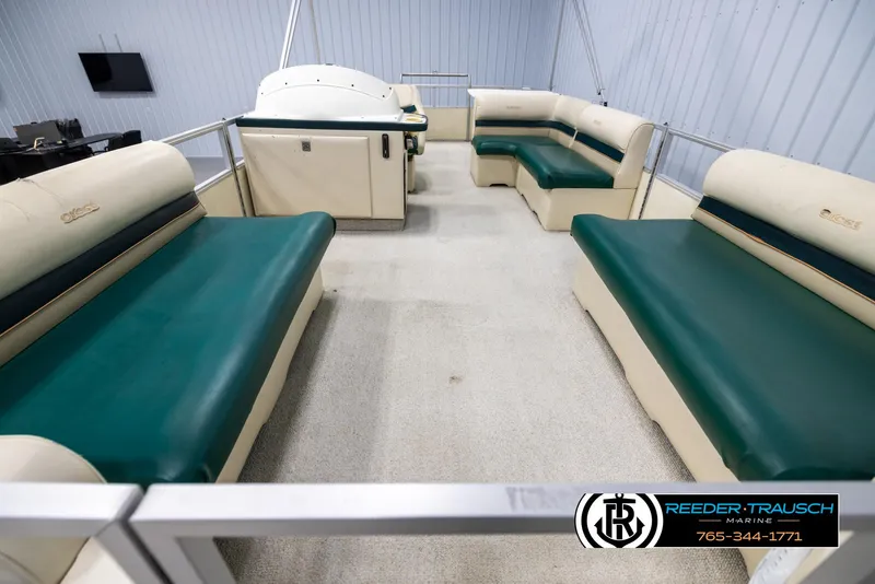 Slide: The Image of Interior of 1998 Crest 22 DLX pontoon boat with green and beige seating. - 13