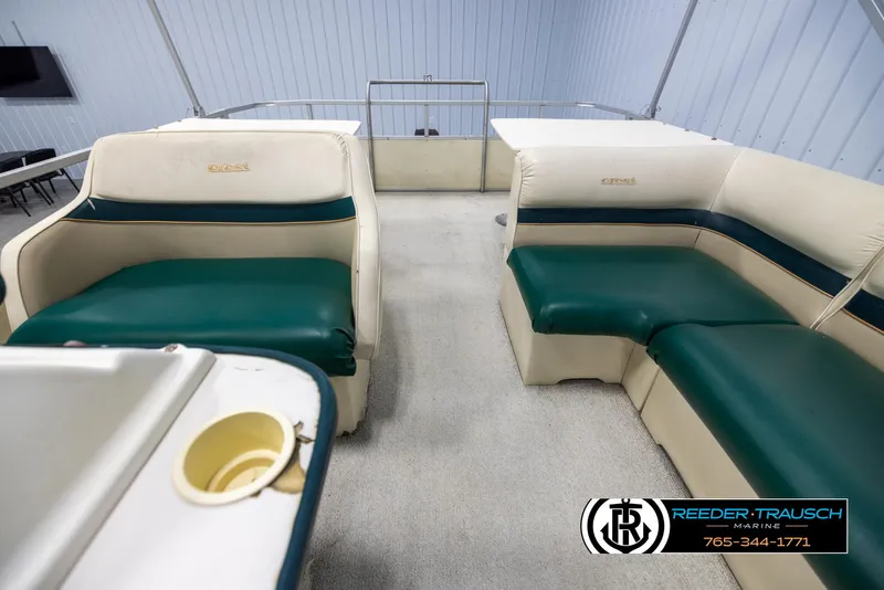 Slide: The Image of Interior of a 1998 Crest 22 DLX boat with green and white seating. - 14