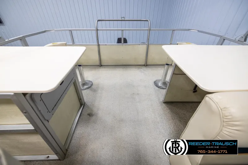 Slide: The Image of Interior of a 1998 Crest 22 DLX pontoon boat with seating and tables. - 15