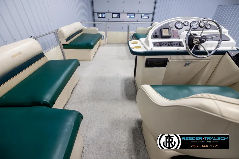 Slide: The Image of Interior of a 1998 Crest 22 DLX boat with green and beige seating. - 17