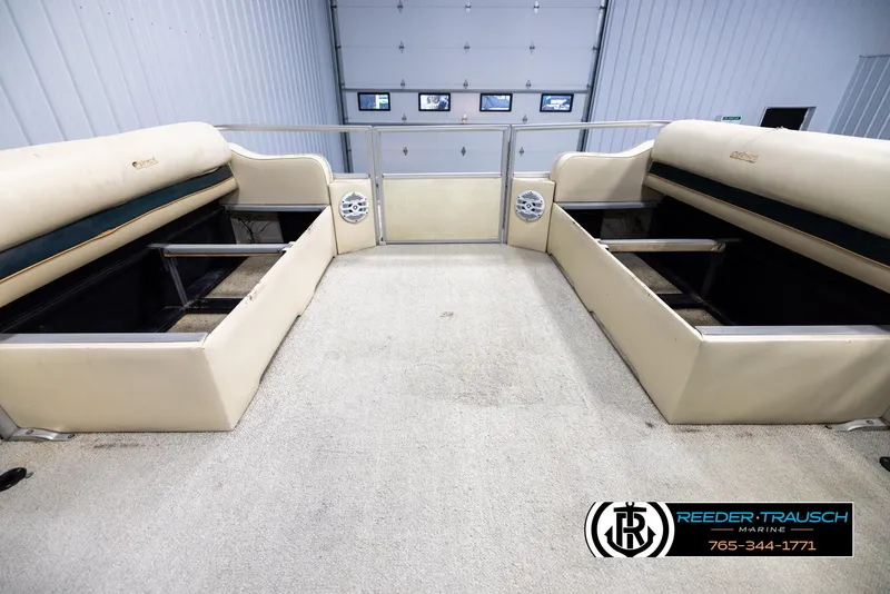Slide: The Image of Interior of a 1998 Crest 22 DLX boat with beige seating and storage compartments. - 19