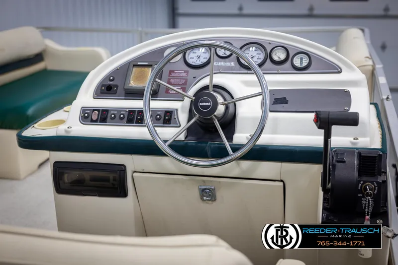 Slide: The Image of Control panel of a 1998 Crest 22 DLX boat with steering wheel and gauges. - 22