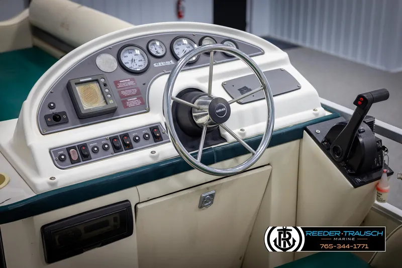 Slide: The Image of 1998 Crest 22 DLX boat dashboard with steering wheel and control panel. - 23