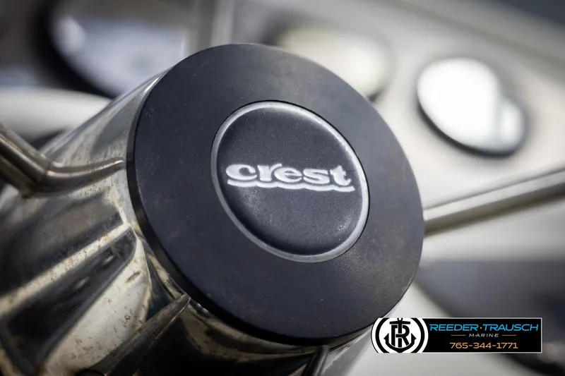 Slide: The Image of Close-up of Crest 22 DLX 1998 steering wheel with logo. - 24