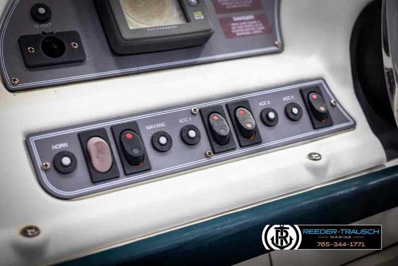 Slide: The Image of Control panel of a 1998 Crest 22 DLX boat with various switches and buttons. - 26