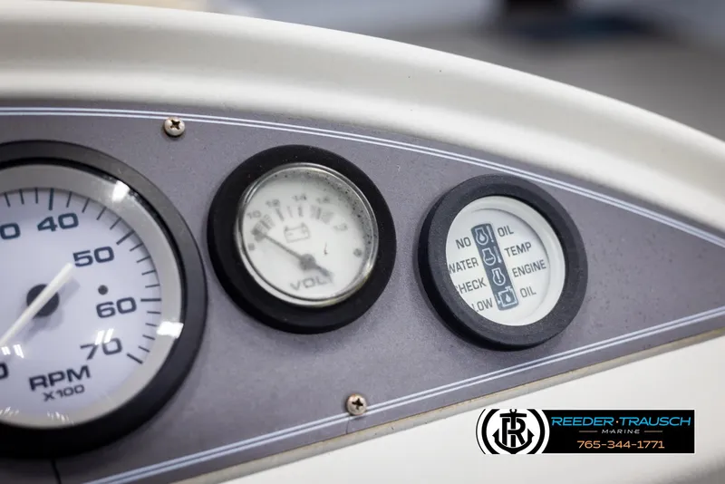 Slide: The Image of Dashboard gauges of a 1998 Crest 22 DLX boat, featuring RPM and volt meters. - 29