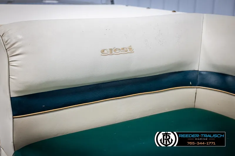 Slide: The Image of Crest 22 DLX 1998 boat seat with logo, featuring white and teal upholstery. - 32