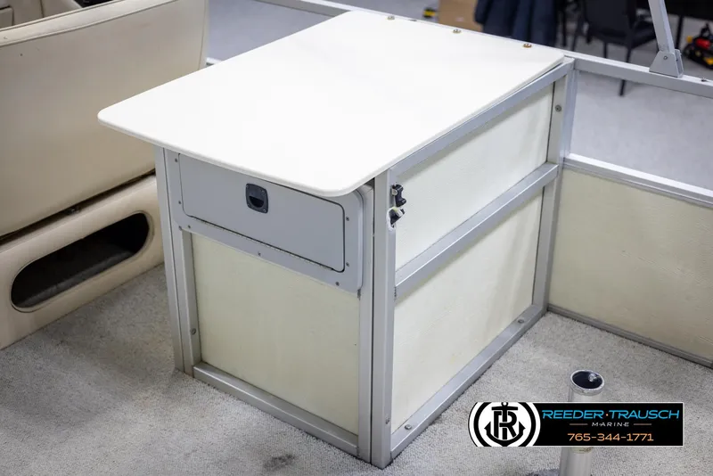 Slide: The Image of 1998 Crest 22 DLX boat interior with storage compartment and table. - 34