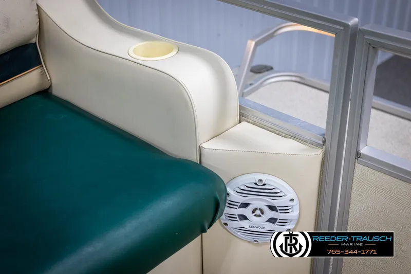 Slide: The Image of Crest 22 DLX 1998 boat interior with green seating and speaker detail. - 35