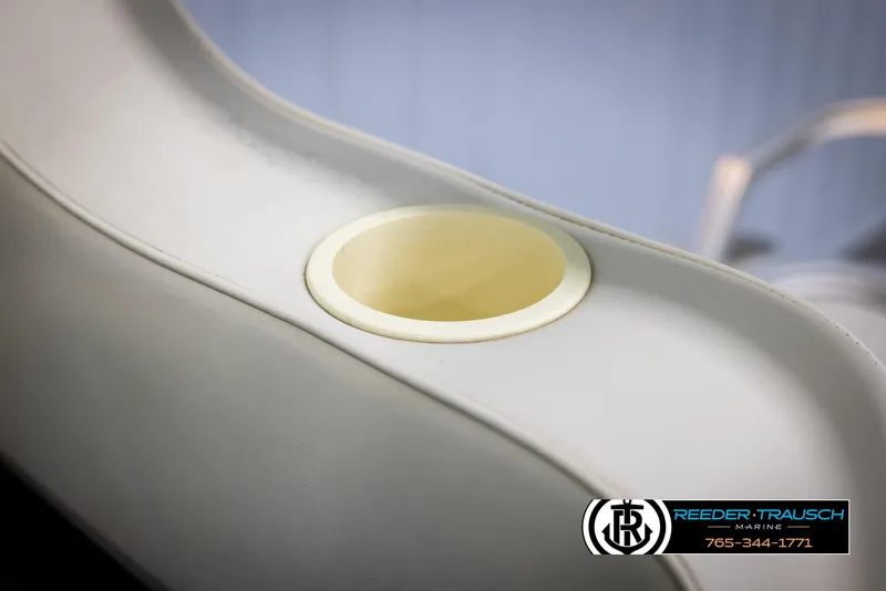 Slide: The Image of Cup holder on 1998 Crest 22 DLX boat seat, Reeder-Trausch Marine logo visible. - 36