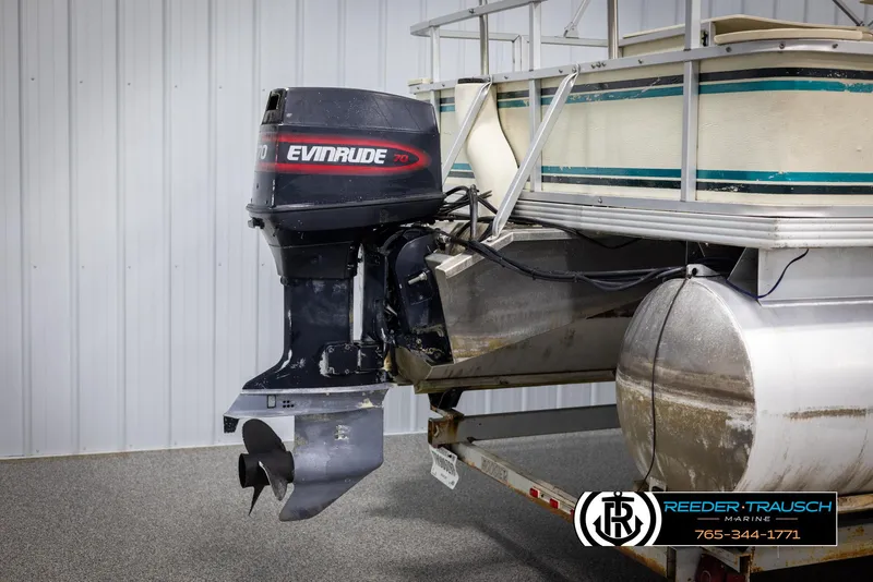 Slide: The Image of 1998 Crest 22 DLX pontoon boat with Evinrude outboard motor in a storage facility. - 37