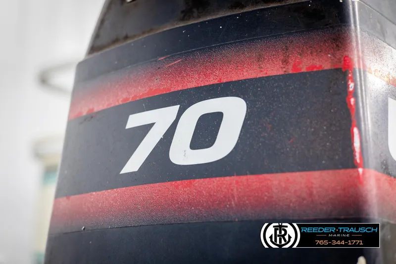 Slide: The Image of Close-up of a Crest 22 DLX 1998 boat engine with "70" marking. - 39