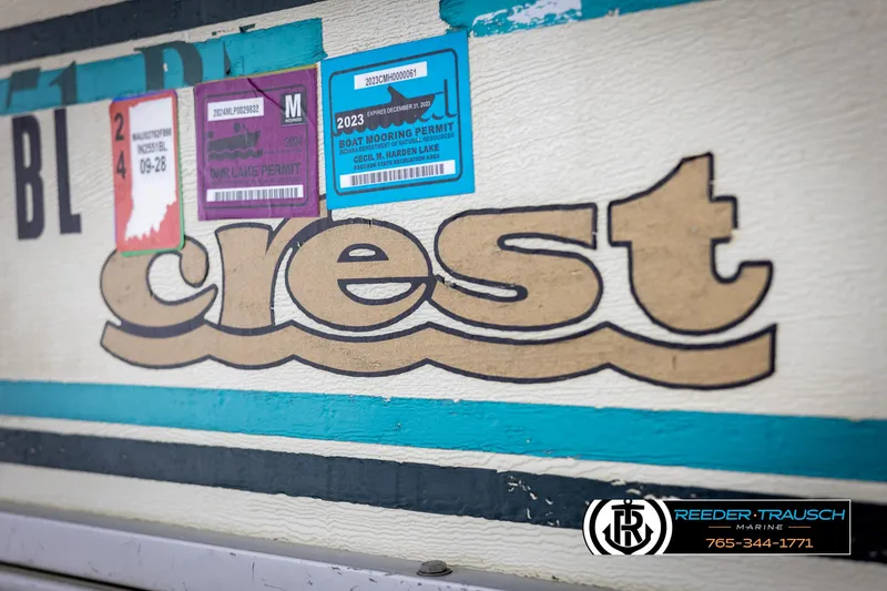 Slide: The Image of Crest 22 DLX 1998 boat with registration stickers and Reeder-Trausch Marine logo. - 40