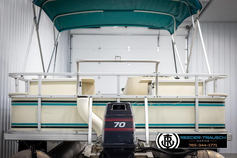 Slide: The Image of 1998 Crest 22 DLX pontoon boat with canopy and 70 HP motor in storage. - 7