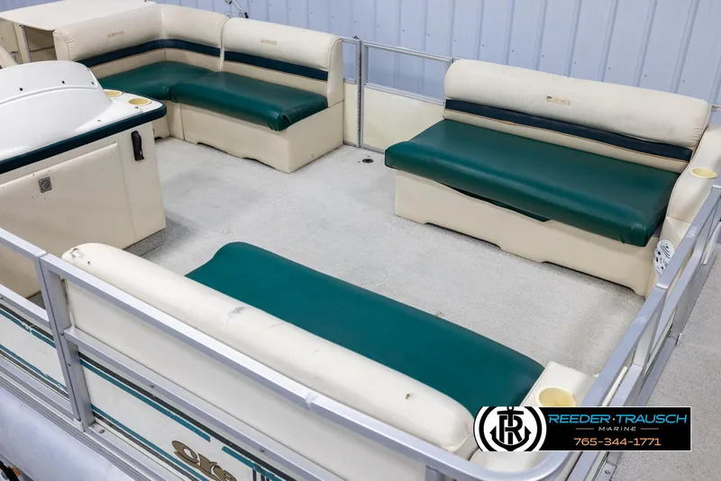 Slide: The Image of 1998 Crest 22 DLX pontoon boat interior with green and beige seating. - 9
