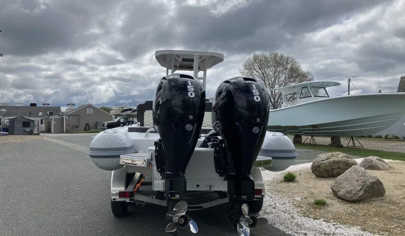 Slide: The Image of 2025 Highfield Sport 800 boat with dual outboard motors on a trailer, cloudy sky background. - 1