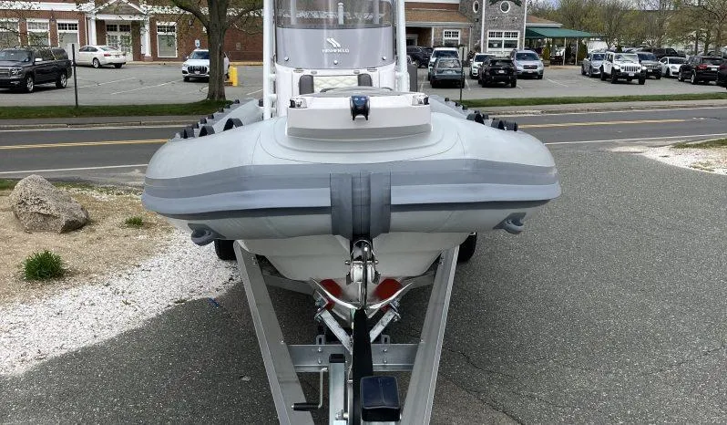 Slide: The Image of 2025 Highfield Sport 800 boat on trailer, parked in urban setting. - 2