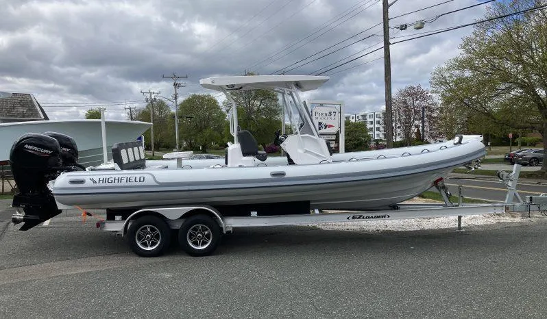 Slide: The Image of 2025 Highfield Sport 800 boat on trailer, parked outdoors under cloudy sky. - 3