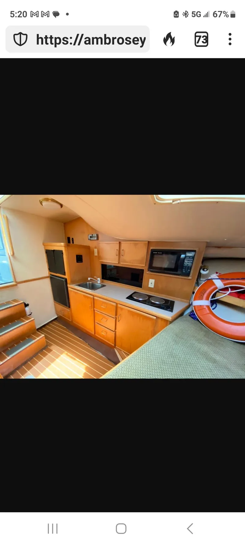 Slide: The Image of Interior of 2000 Dawson Yachts 33 EXPRESS, featuring a compact kitchen with wooden cabinetry. - 11