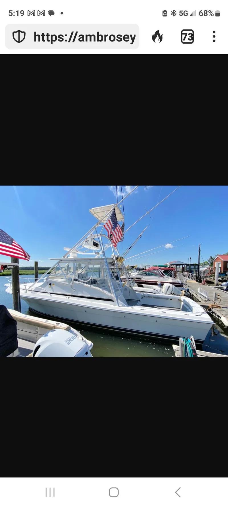 Slide: The Image of 2000 Dawson Yachts 33 EXPRESS docked, featuring American flags and clear blue skies. - 3