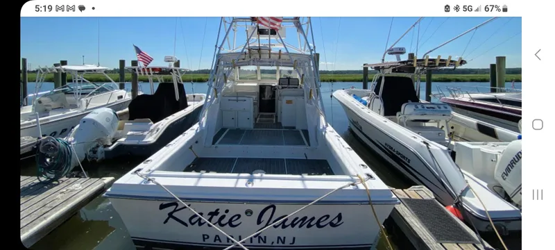 Slide: The Image of Dawson Yachts 33 EXPRESS 2000 docked, rear view with "Katie James" name visible. - 0