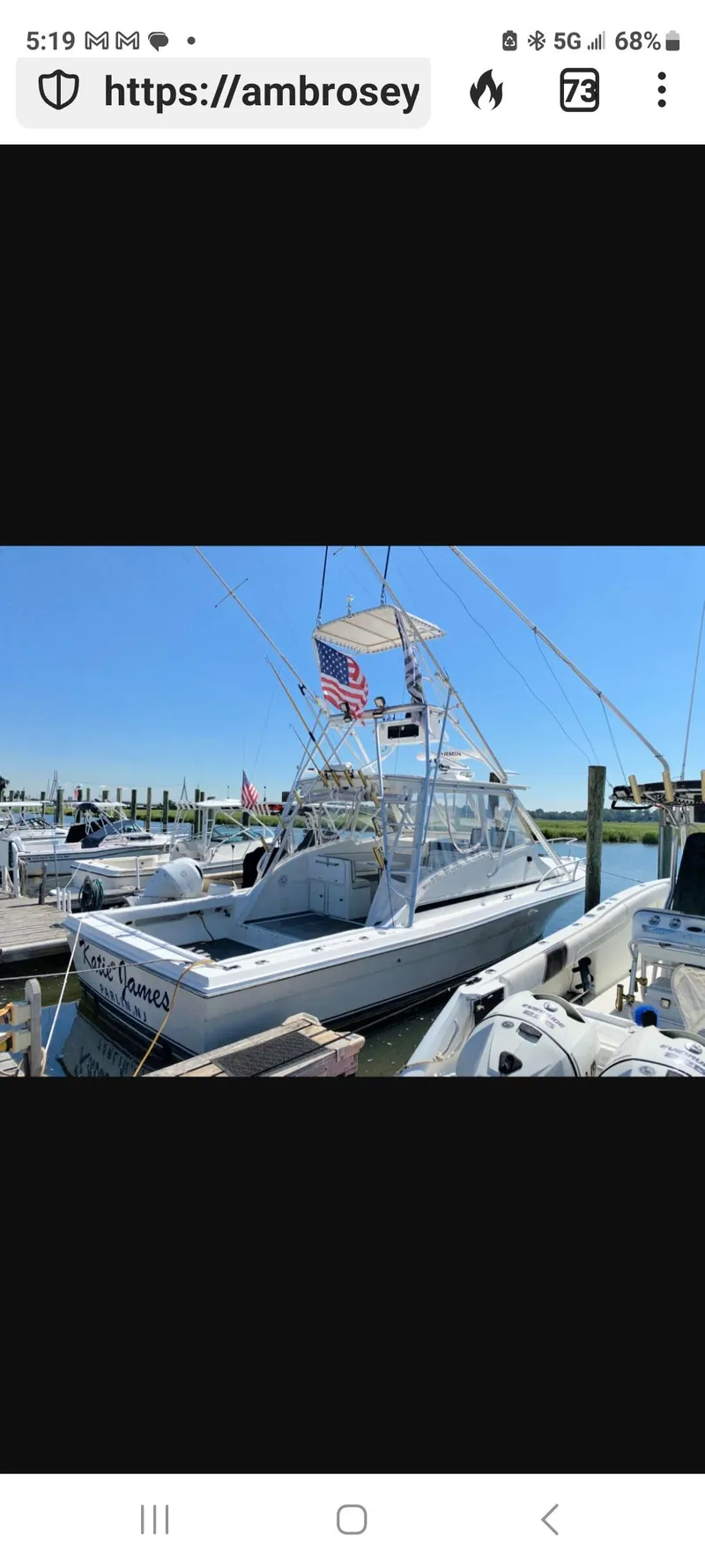 Slide: The Image of Dawson Yachts 33 EXPRESS 2000 docked, featuring American flag, clear blue sky. - 1