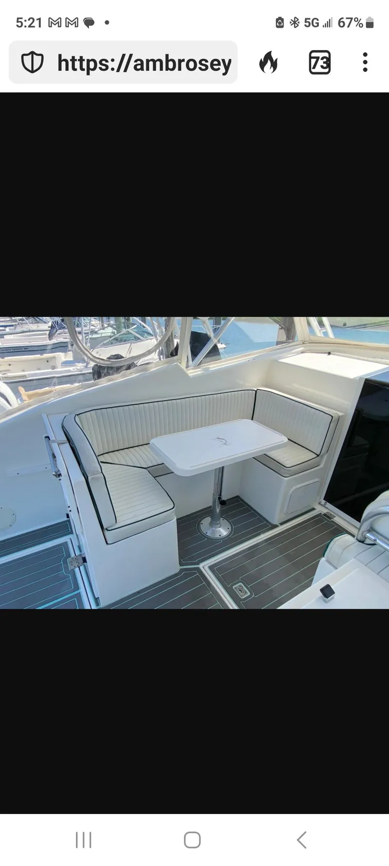 Slide: The Image of Interior seating area of 2000 Dawson Yachts 33 EXPRESS with table and cushioned benches. - 23