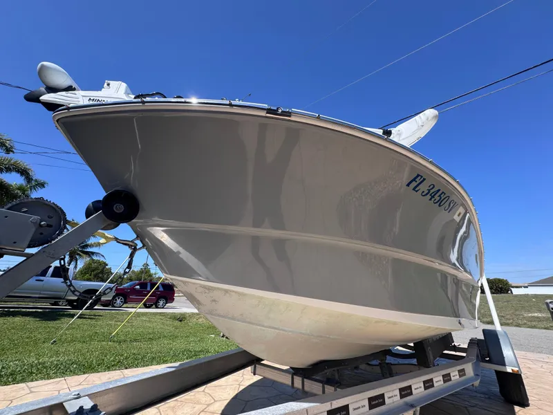 Slide: The Image of Clearwater 2000 C/C boat for sale, 2021 model, with Minn Kota motor, under blue sky. - 10