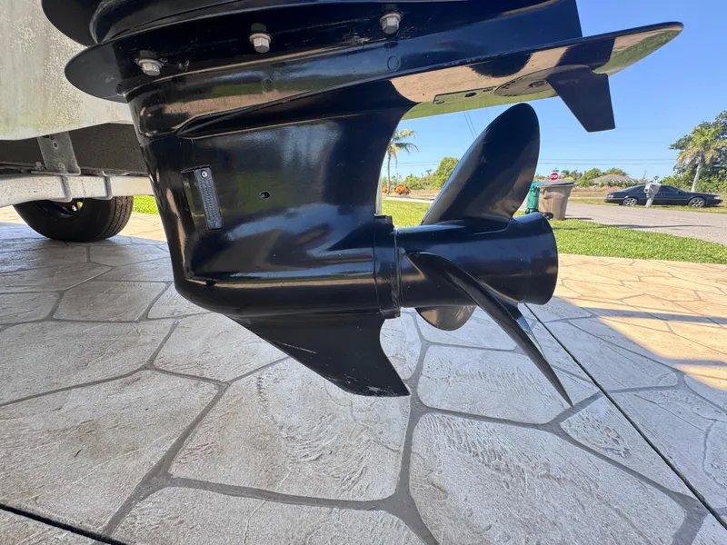 Slide: The Image of 2021 Clearwater 2000 C/C boat interior with seating and steering console, parked in a marina. - 15