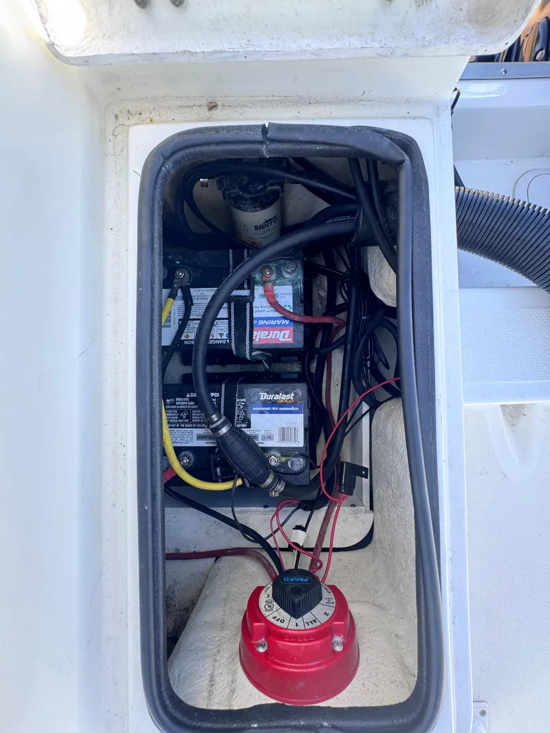 Slide: The Image of Clearwater 2000 C/C 2021 boat interior with steering console and rod holders. - 17