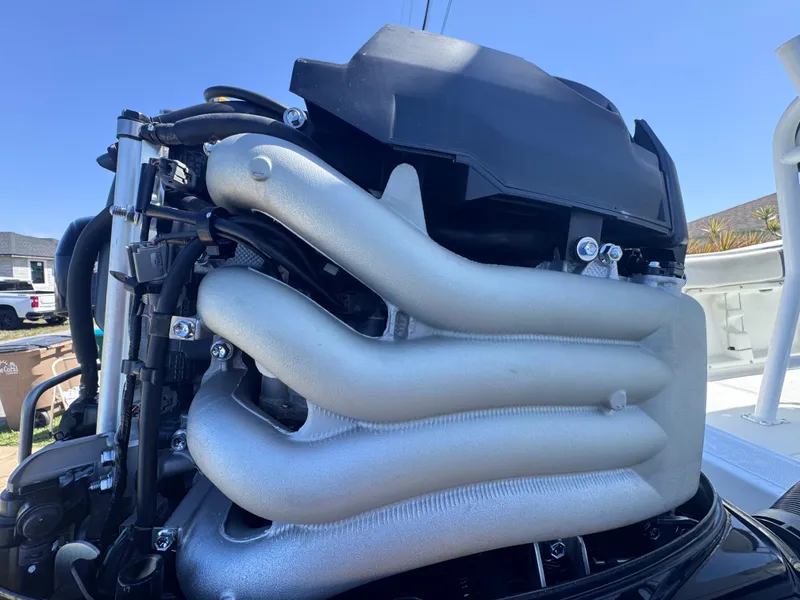 Slide: The Image of Clearwater 2000 C/C 2021 boat dashboard with steering wheel and gauges in a marina setting. - 19