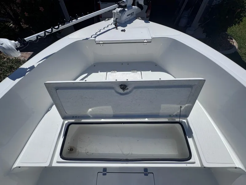 Slide: The Image of Clearwater 2000 C/C 2021 boat deck with storage compartments and trolling motor. - 28