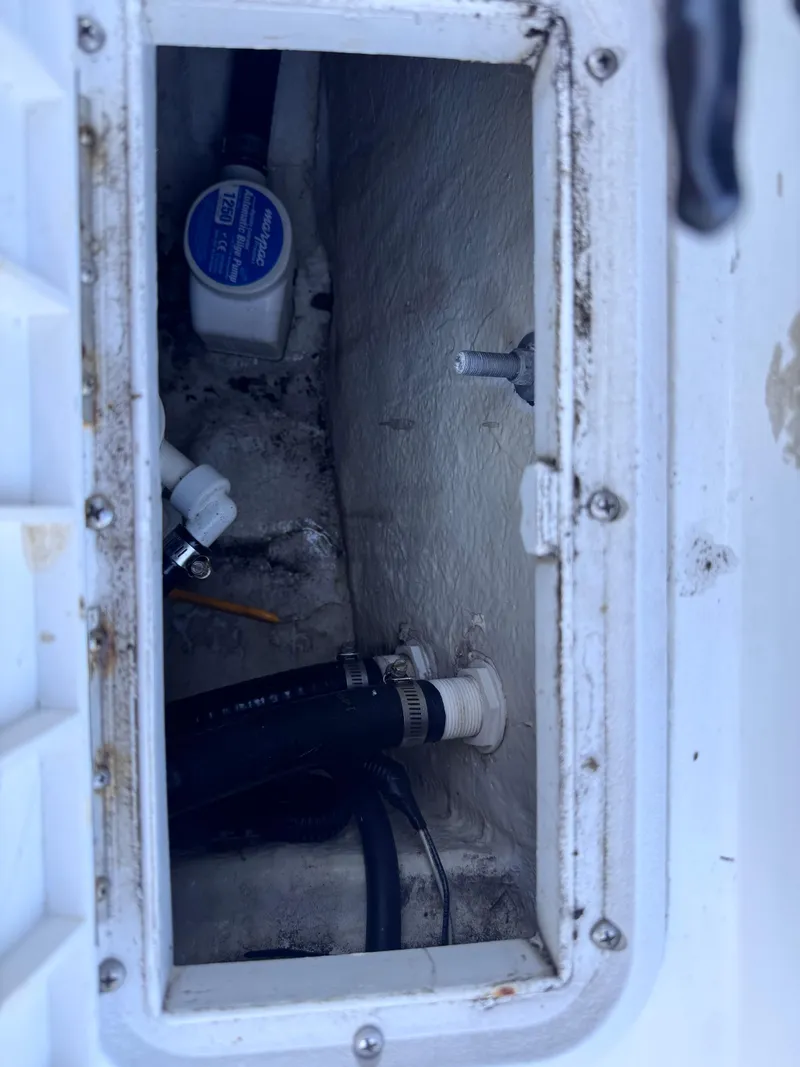 Slide: The Image of Open storage compartment on 2021 Clearwater 2000 C/C boat with coiled rope inside. - 49