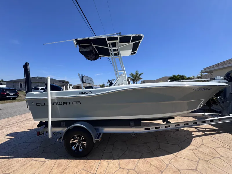 Slide: The Image of 2021 Clearwater 2000 C/C boat on trailer under cloudy sky. - 7